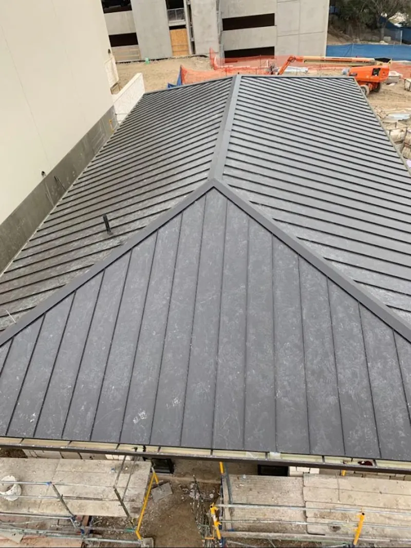 Commercial metal roof construction with crane equipment in Halawa