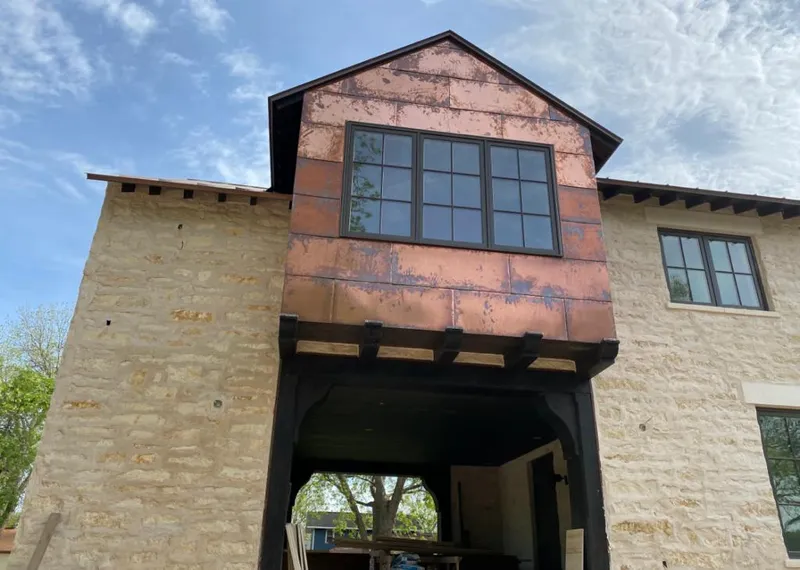 Copper metal panel facade on a stone building for Skylight Installation in Halawa
